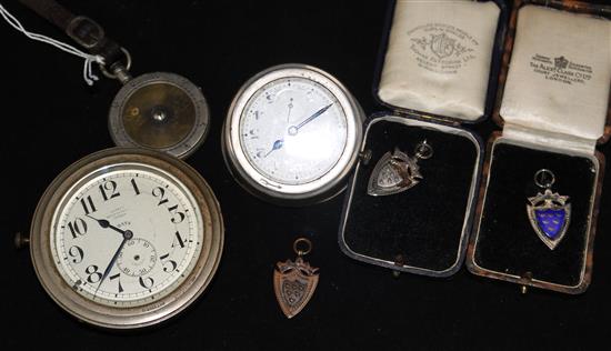 An Asprey motoring timepiece, a similar timepiece, a game scorer and three medallions